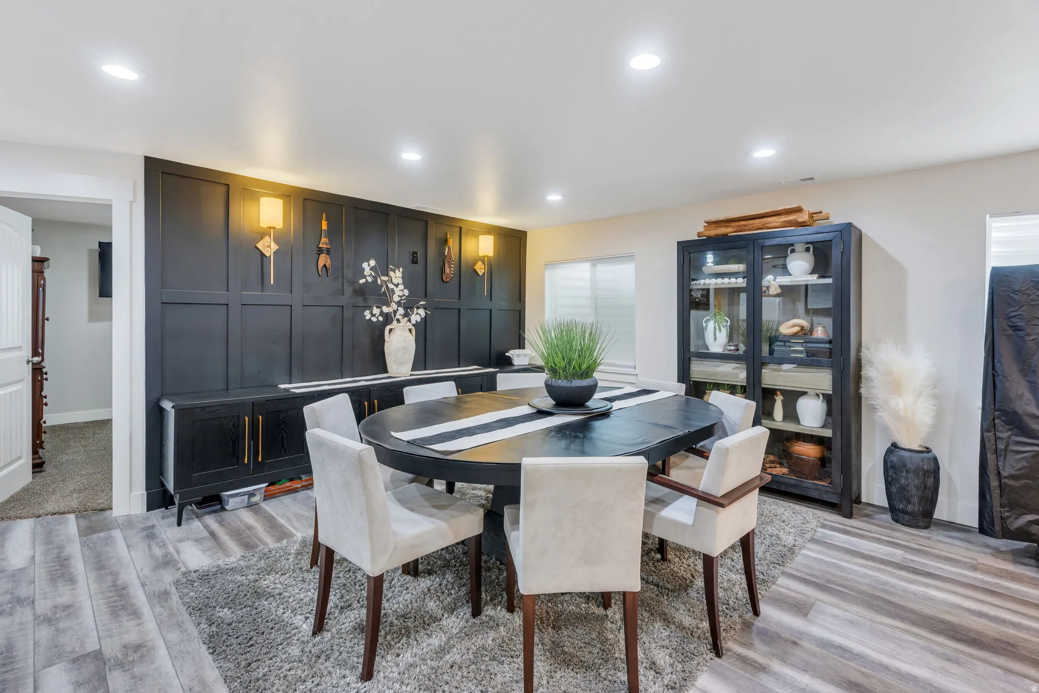 Feature wall with paneling and integrated sconces