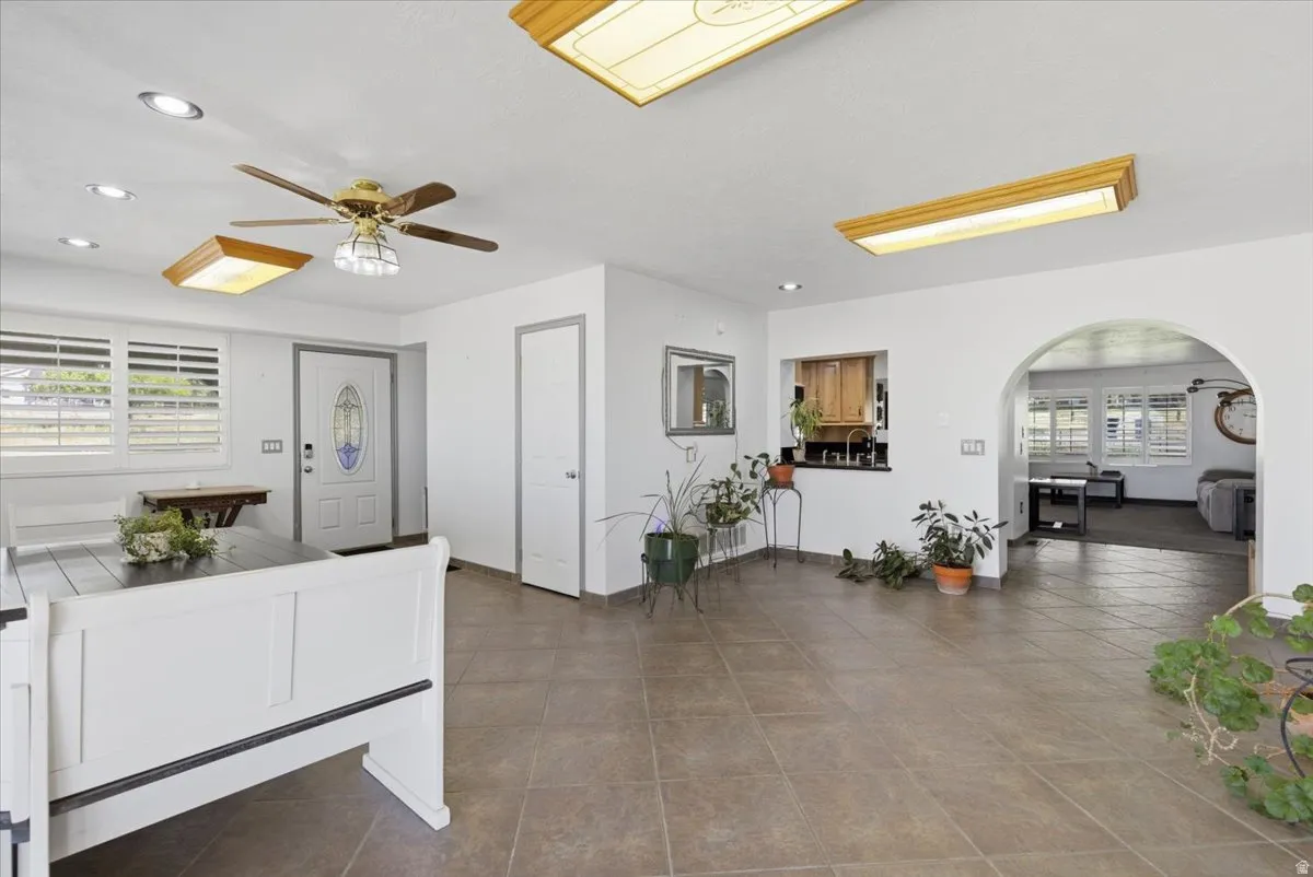 Spacious interior featuring tile flooring, white walls, and multiple ceiling light fixtures