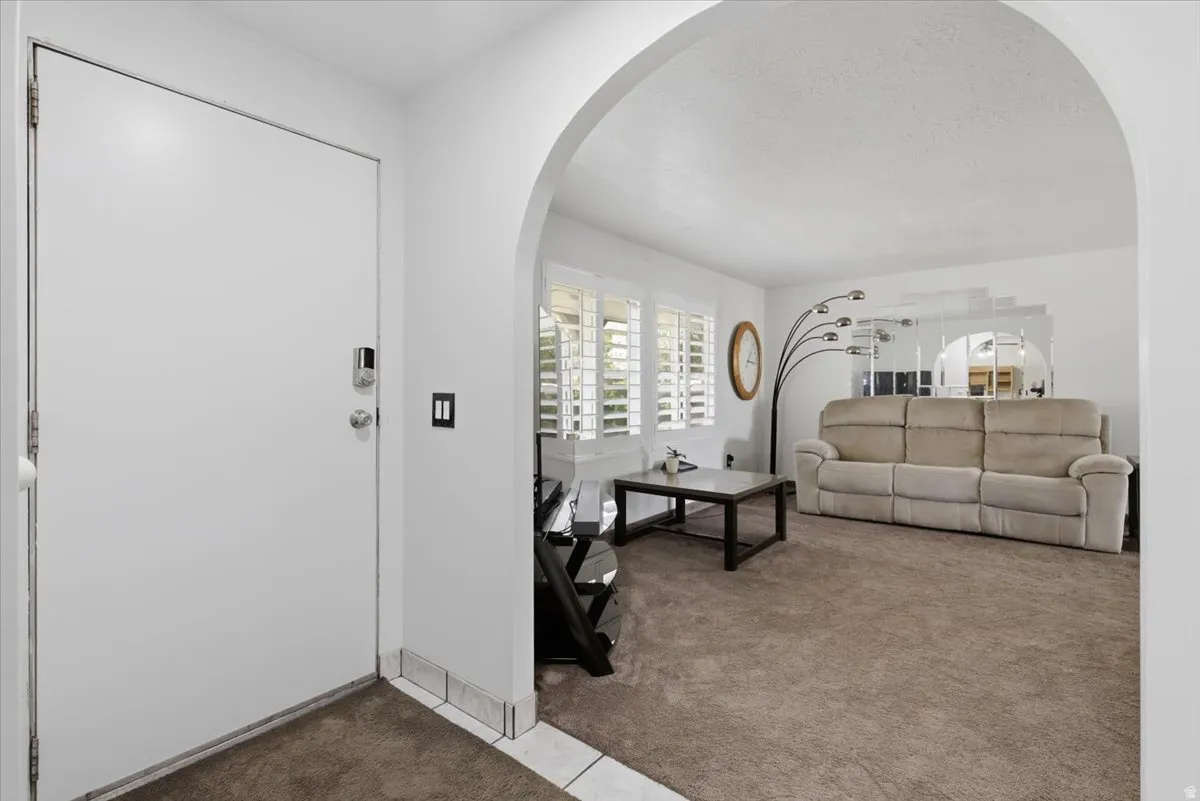 Entryway featuring a white door with a digital lock and a tiled threshold
