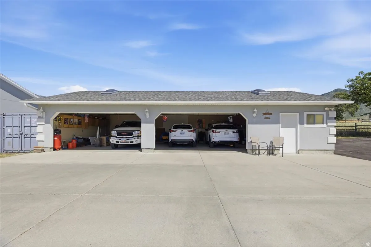 Three-bay garage structure with a light grey exterior