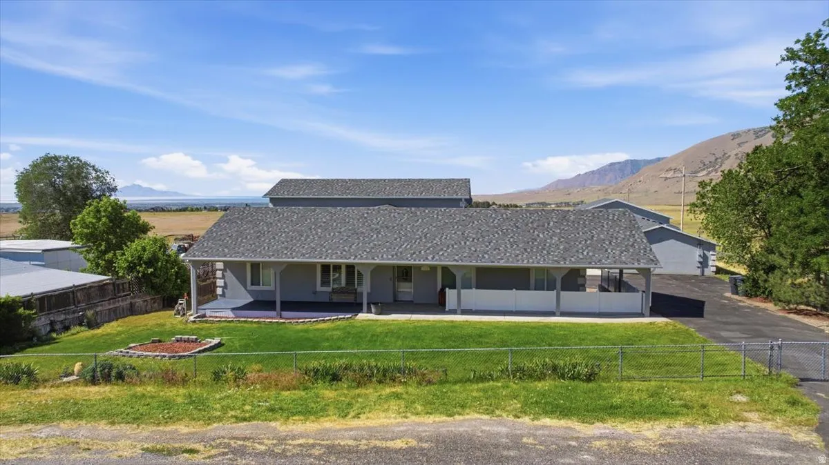 Single-story residence featuring a covered front porch and a paved driveway