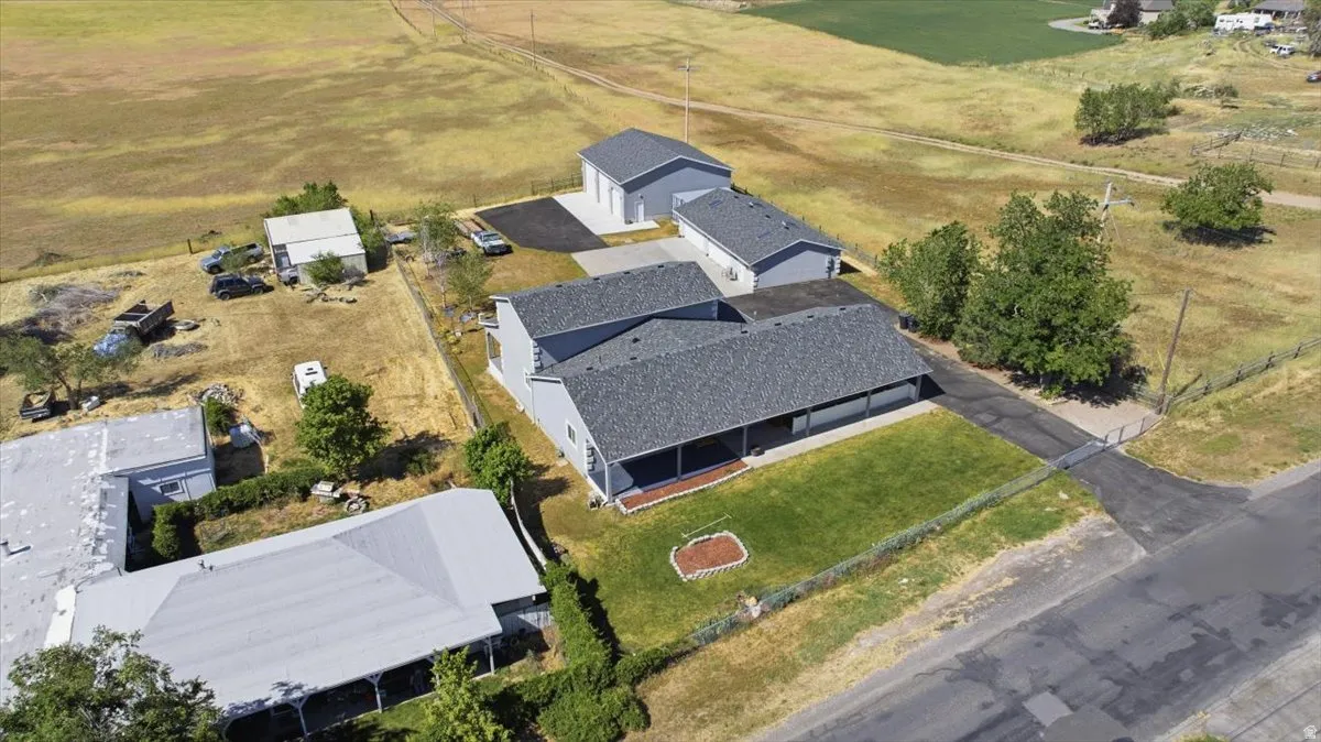 Single-story residence with a covered porch, an attached garage, and a detached two-car garage