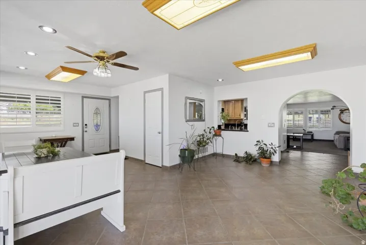 Spacious interior featuring tile flooring, white walls, and multiple ceiling light fixtures