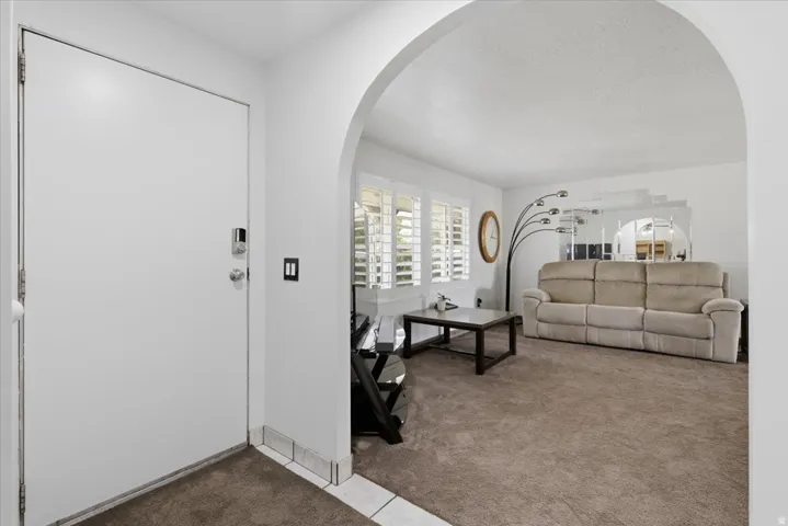 Entryway featuring a white door with a digital lock and a tiled threshold