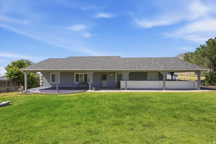 Ranch-style residence featuring a full-length covered porch with white columns
