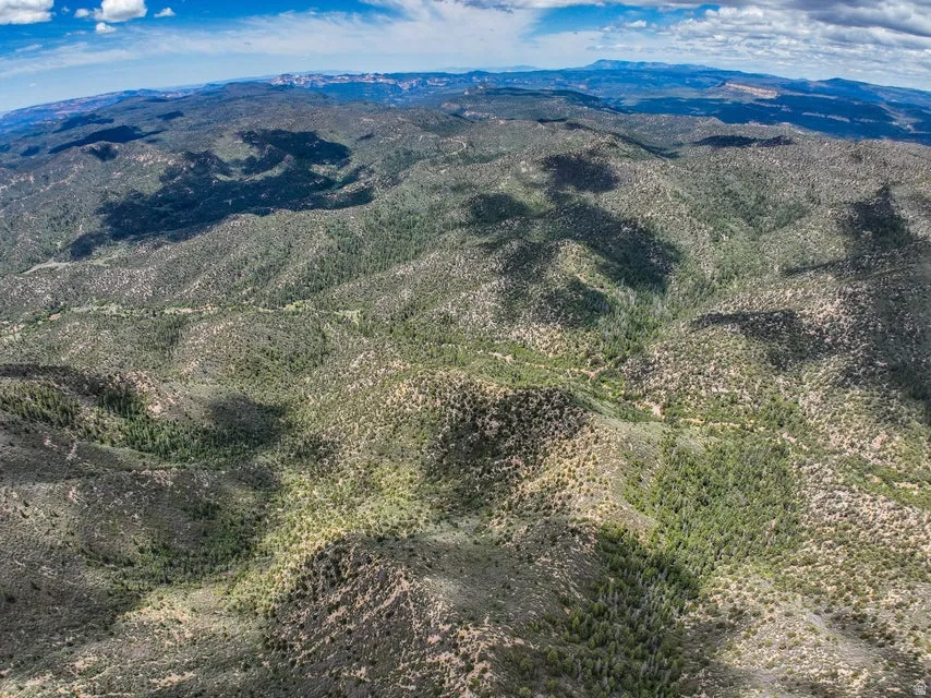 Expansive natural landscape featuring rolling hills and varied topography