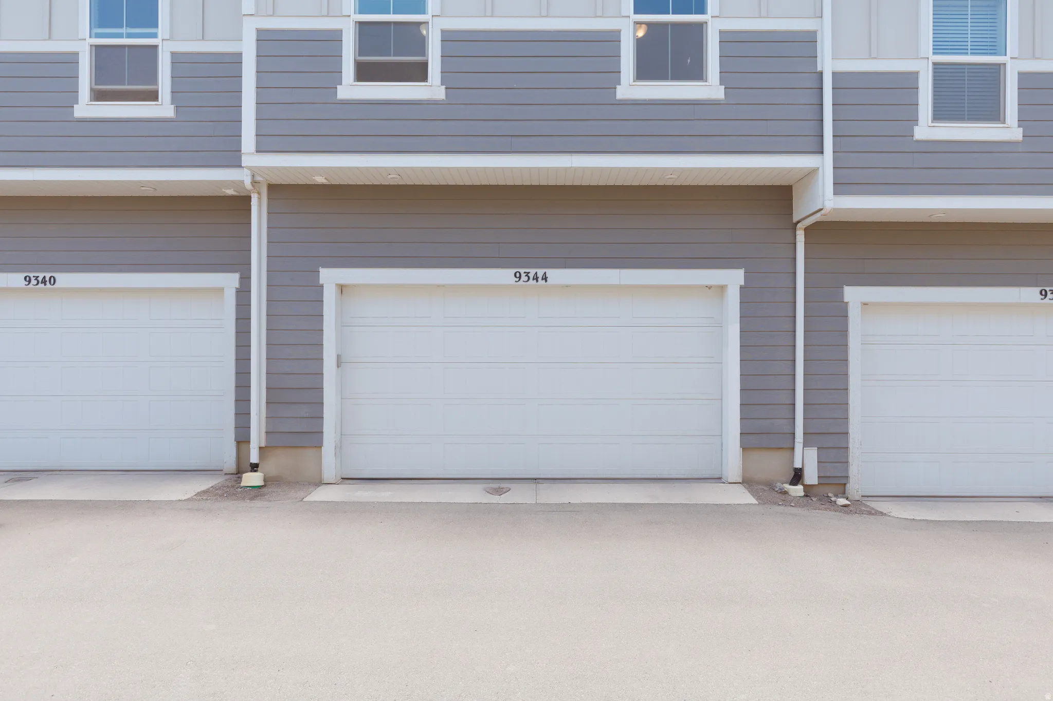 Exterior featuring gray horizontal siding and white trim