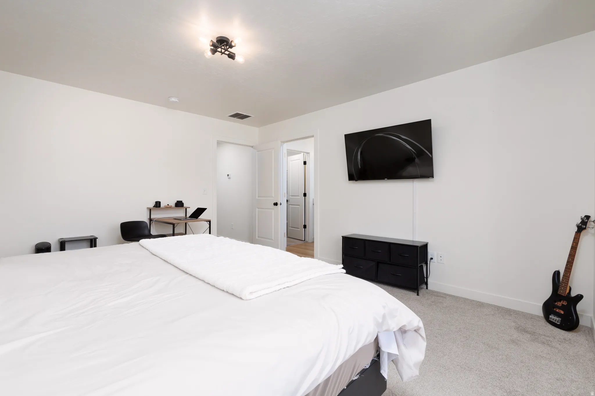 Neutral white walls and light gray carpeting