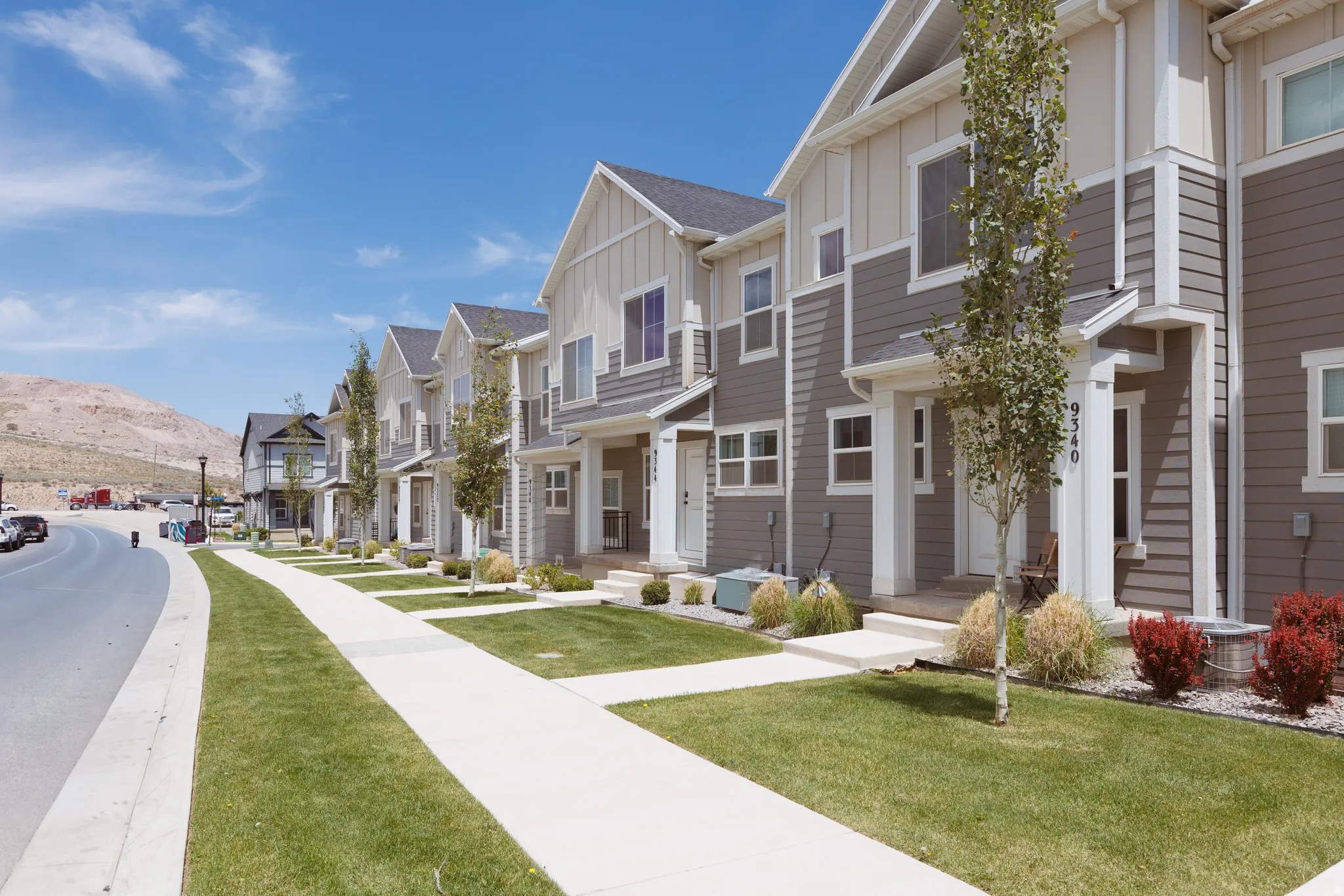 Contemporary townhome exteriors featuring multi-toned siding and white trim
