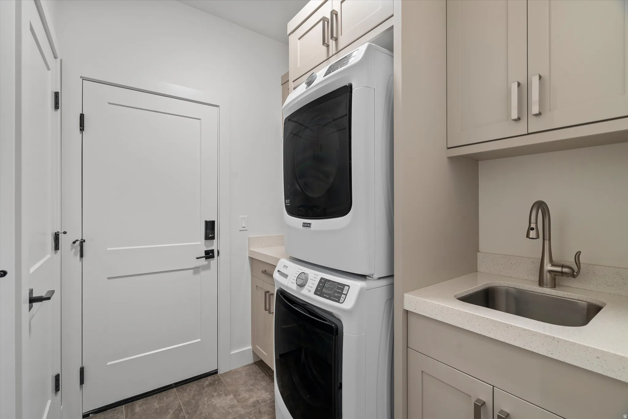 Laundry and utility area featuring owner's closet, a built-in sink, washer/dryer.