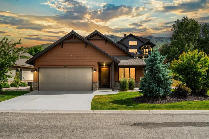 Craftsman-style home featuring a two-car garage on a corner lot.