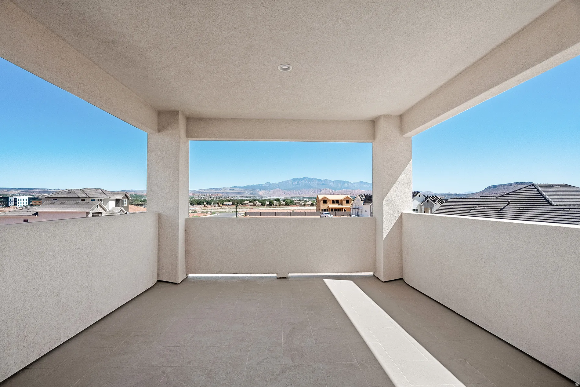 Upstairs deck Spacious outdoor balcony featuring durable tile flooring and stucco walls