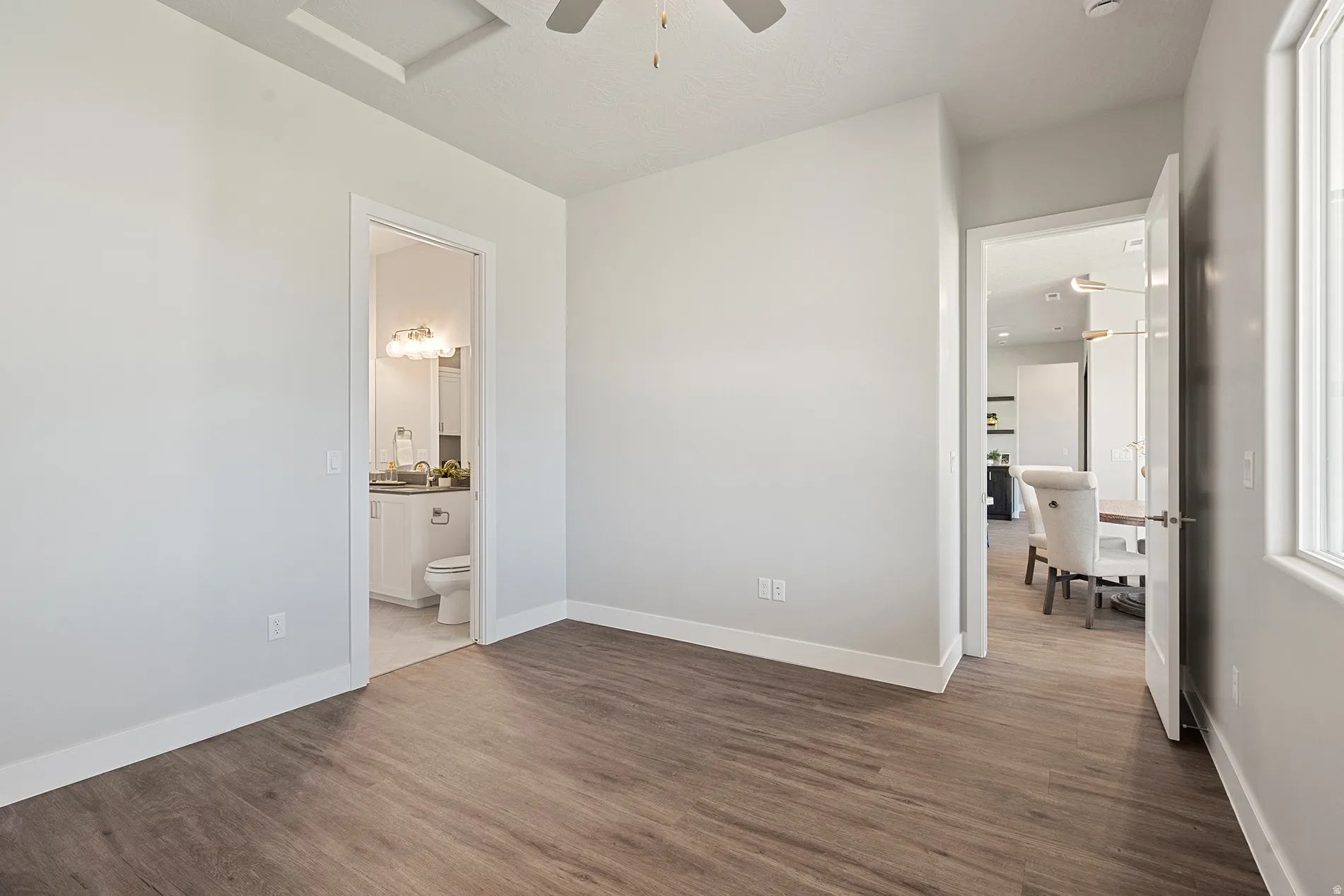 Spacious room featuring wood-finish flooring and neutral wall tones