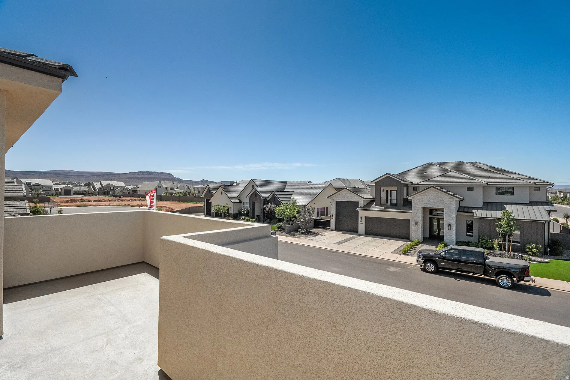Upper-level balcony with stucco walls and concrete flooring