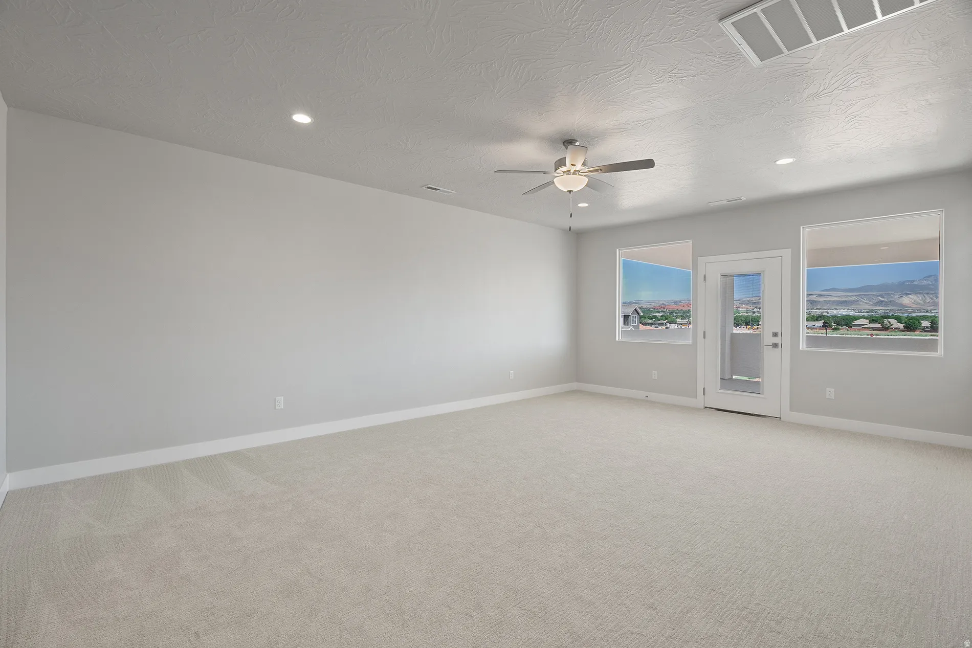 Upstairs Spacious room featuring light-colored carpeting, recessed lighting, and a ceiling fan
