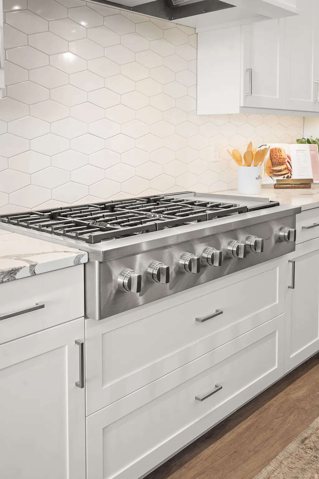Stainless steel professional-grade range with a coordinating range hood