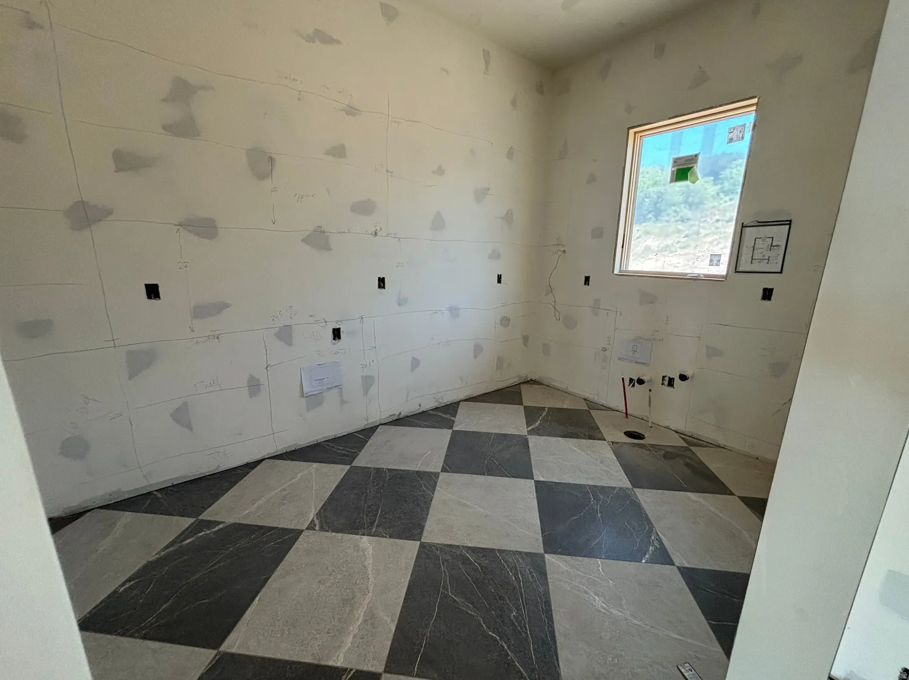 Pantry featuring checkered floor tiling, and a window letting in natural light