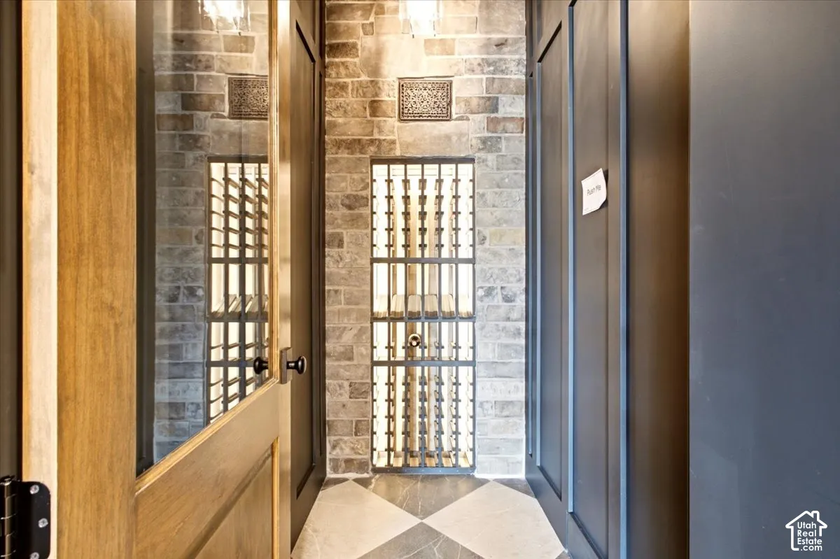 Custom wine cellar featuring a stone wall, and a secret door