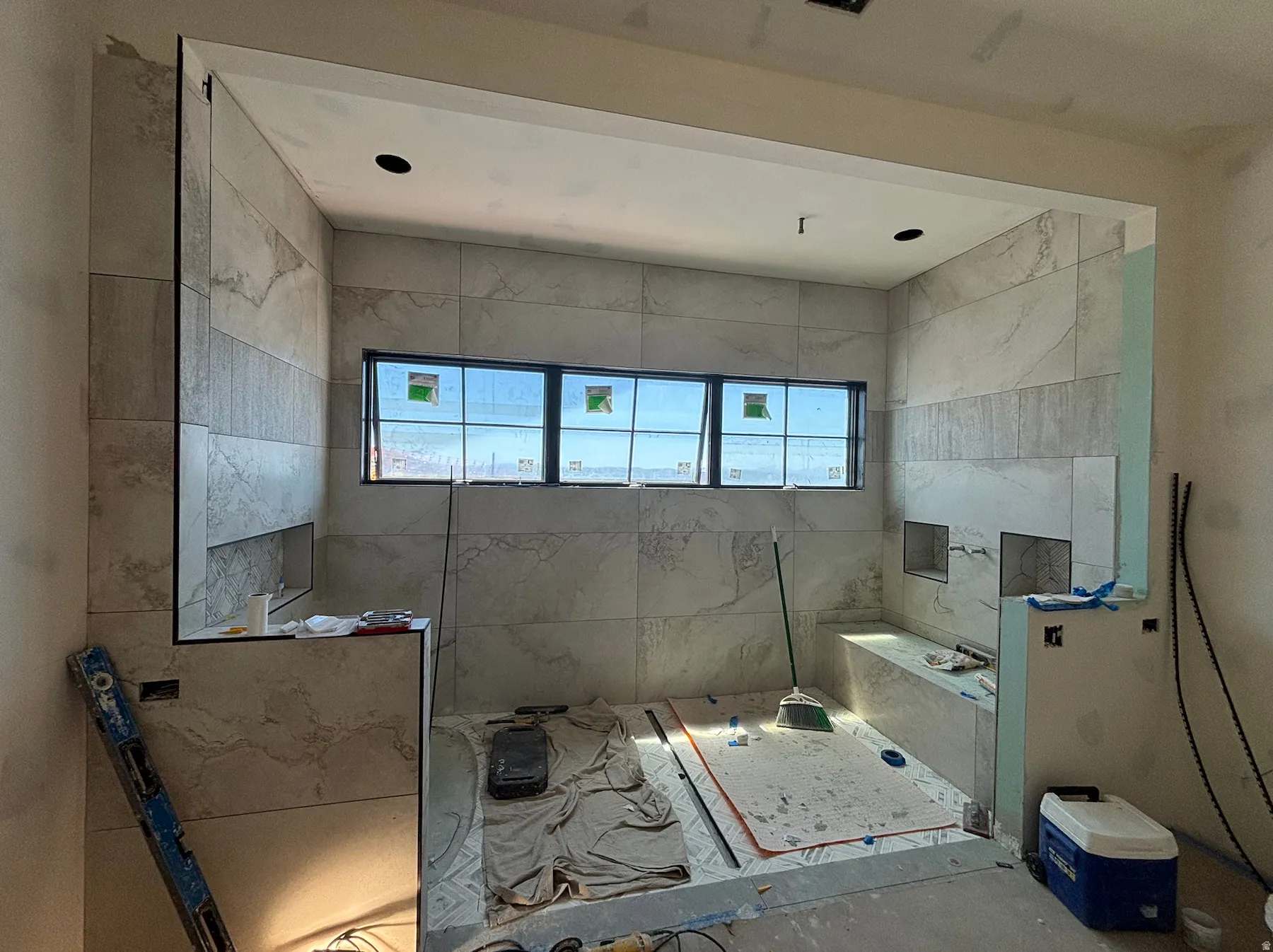 Master bathroom shower featuring multiple built-in niches, and a functional integrated bench, and views of Mount Timpanogos and Jordanelle Reservoir