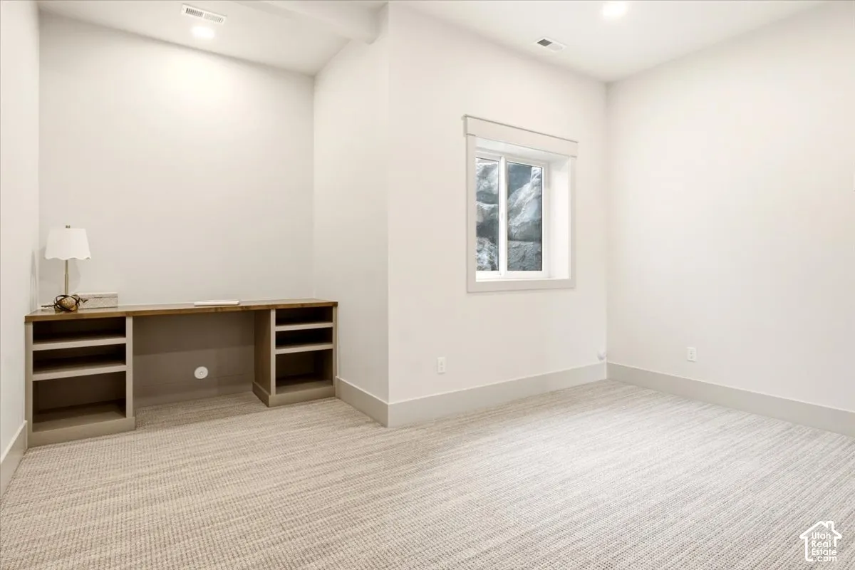 Bedroom featuring a built-in desk with integrated shelving