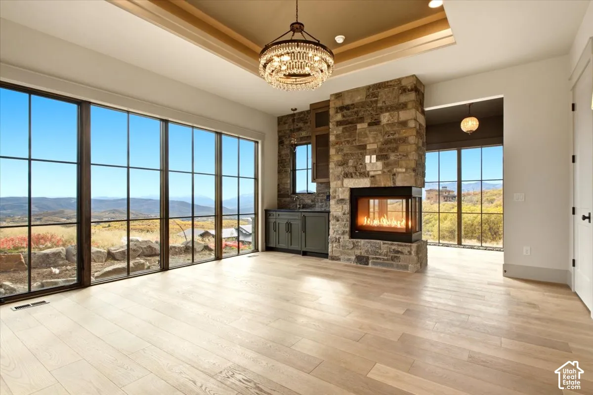 Owner's suite featuring a peninsula fireplace, and views of Mount Timpanogos and Jordanelle Reservoir