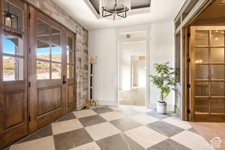 Entrance Foyer featuring checkered tile floor, and a stone wall