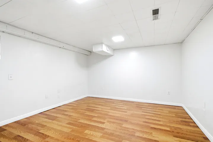 Room featuring wood-finish flooring and white baseboards
