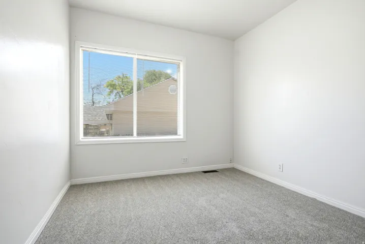 Neutral white walls and light gray carpeting