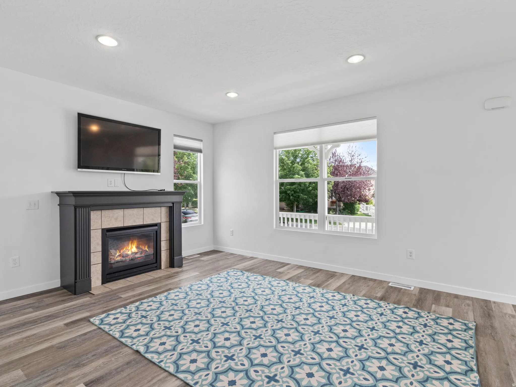 Living area featuring a gas fireplace with a tiled surround and dark wood mantel
