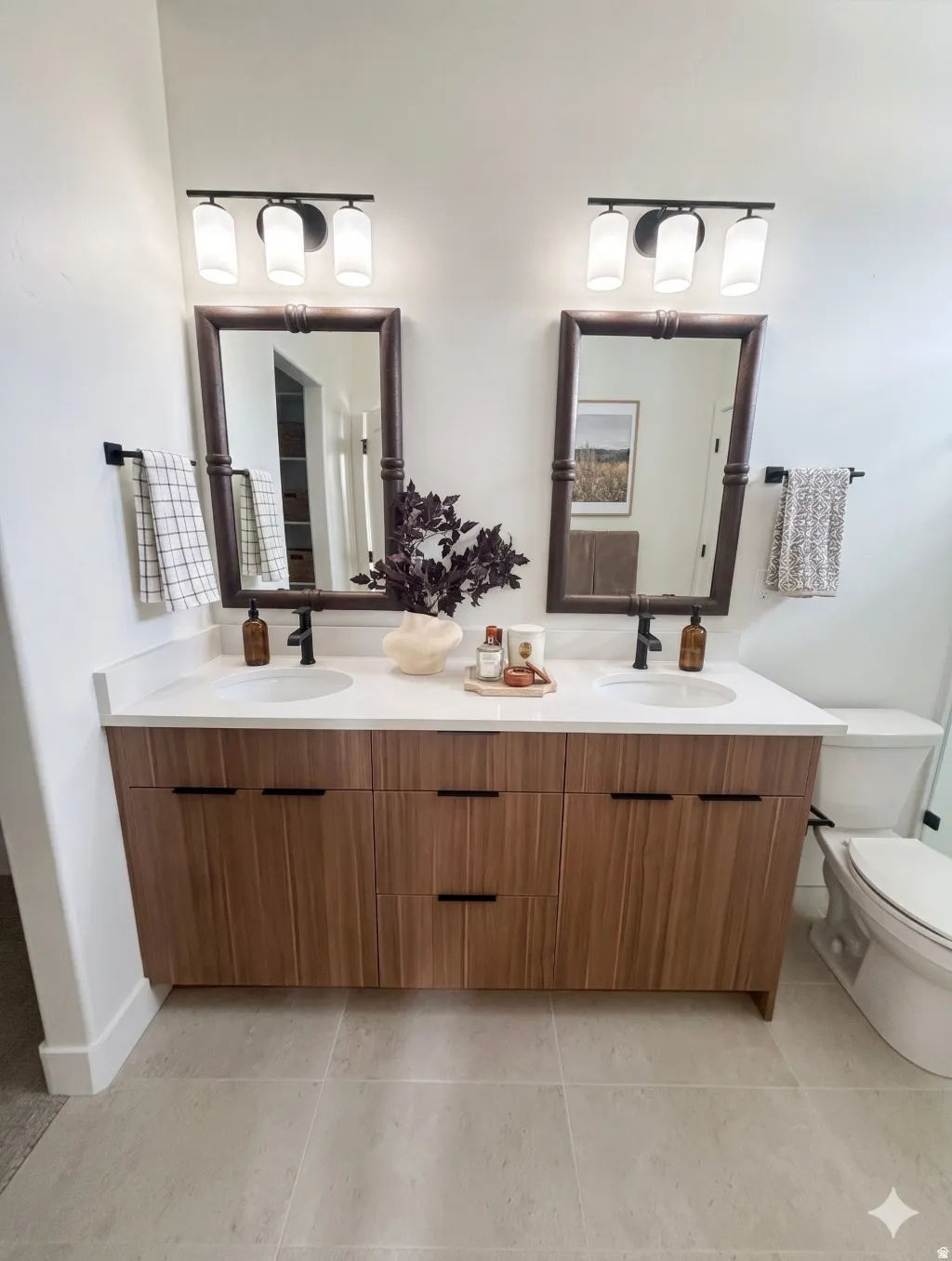 Dual vanity with wood-finish cabinetry, white countertops, and integrated sinks