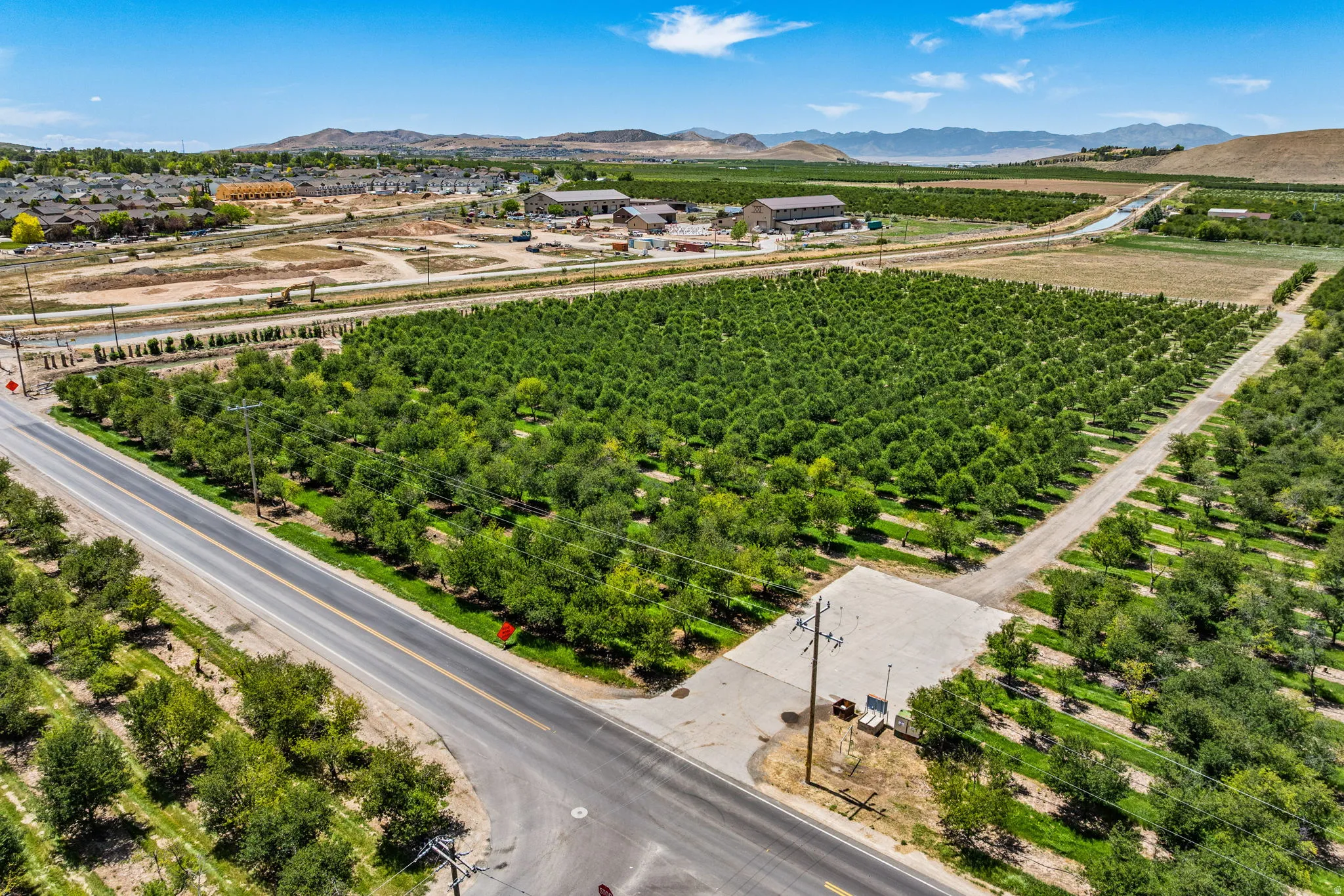 Expansive agricultural property featuring multiple cultivated fields and mature cherry trees