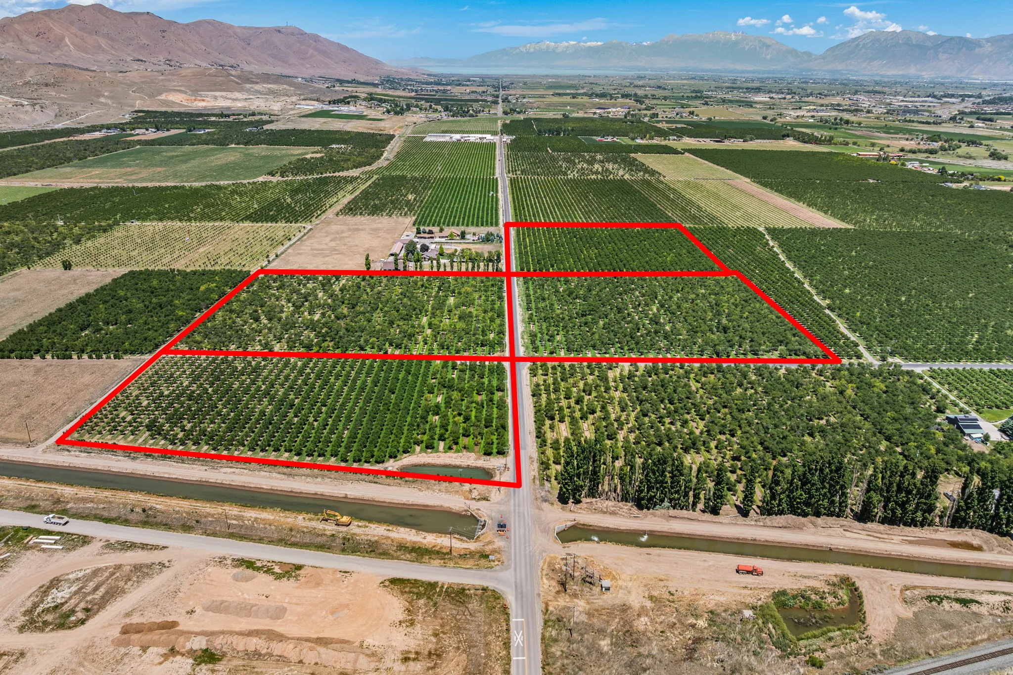 Expansive agricultural property featuring multiple cultivated fields and mature cherry trees