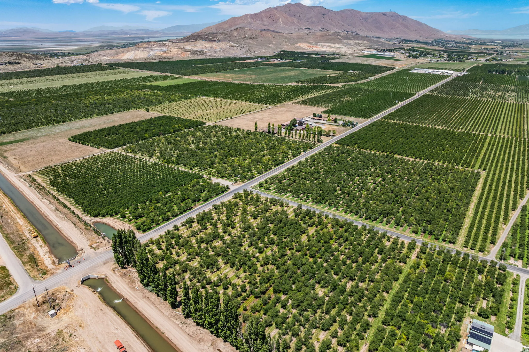 Expansive agricultural property featuring multiple cultivated fields and mature cherry trees