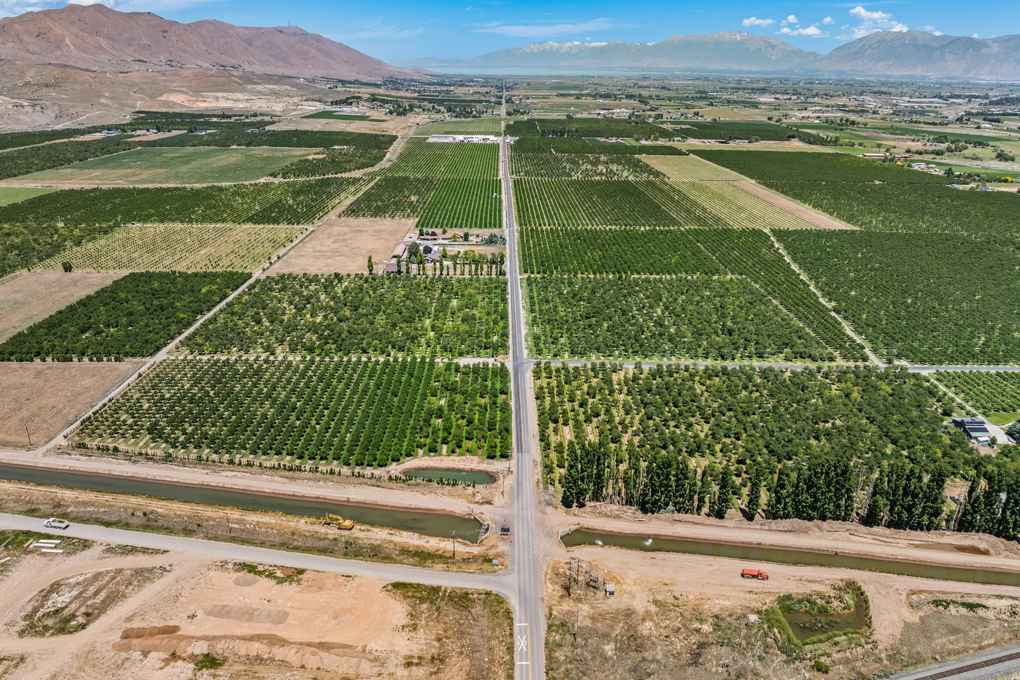 Expansive agricultural property featuring multiple cultivated fields and mature cherry trees
