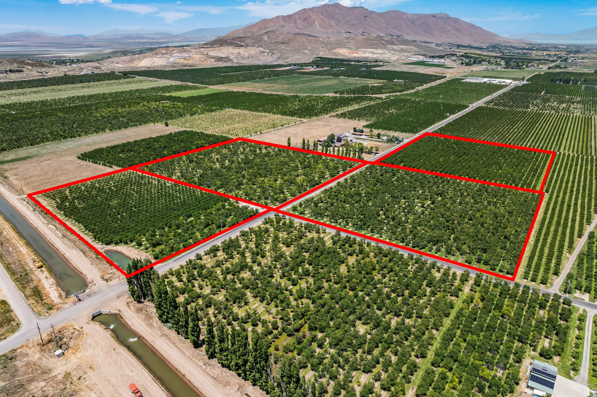 Expansive agricultural property featuring multiple cultivated fields and mature cherry trees