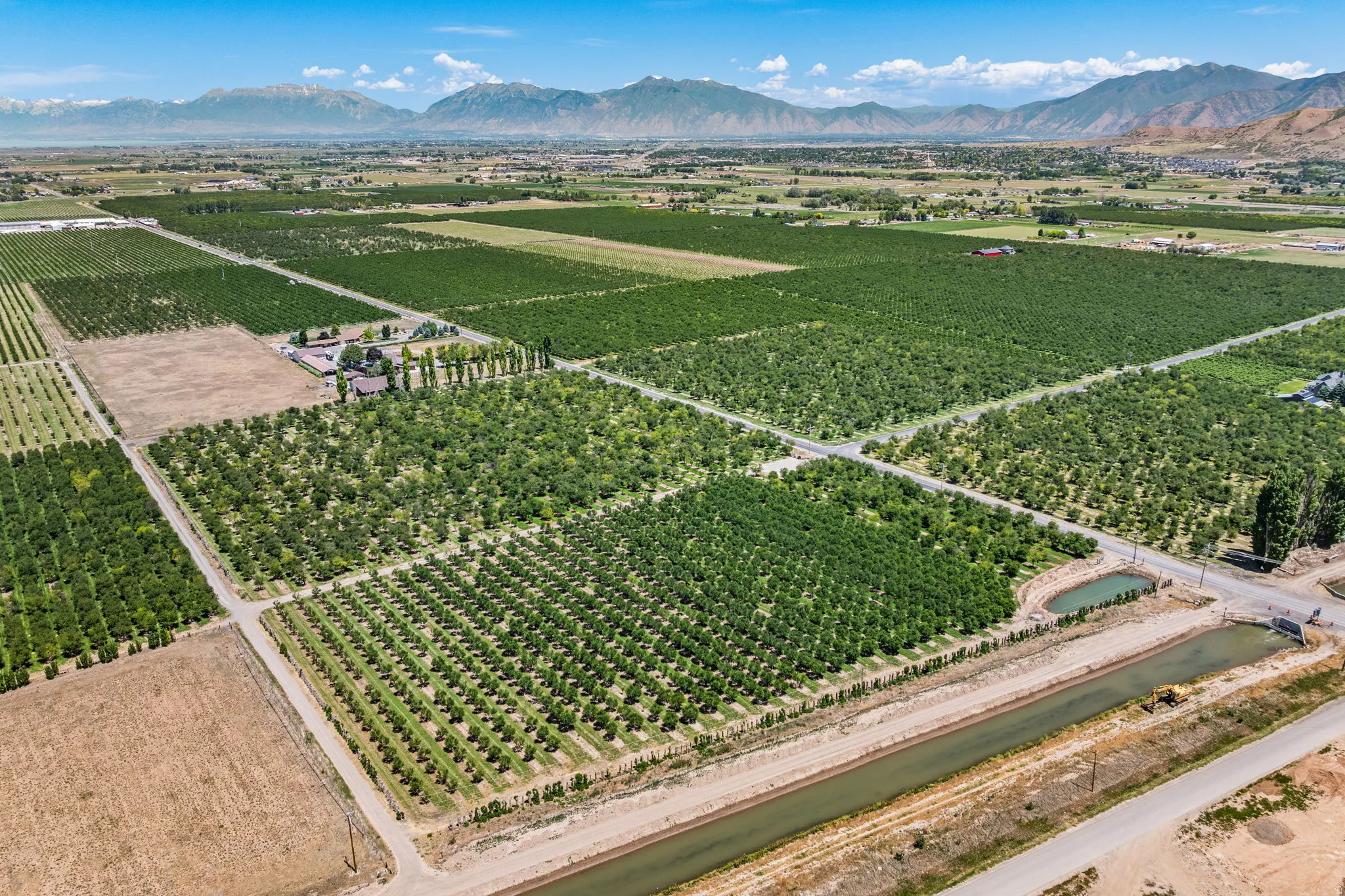 Expansive agricultural property featuring multiple cultivated fields and mature cherry trees