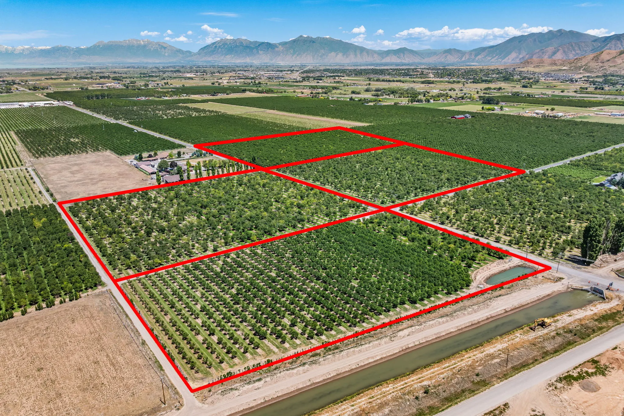 Expansive agricultural property featuring multiple cultivated fields and mature cherry trees