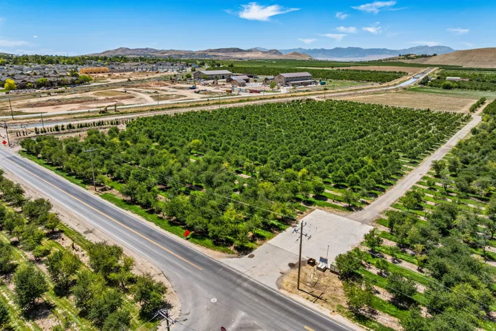 Expansive agricultural property featuring multiple cultivated fields and mature cherry trees