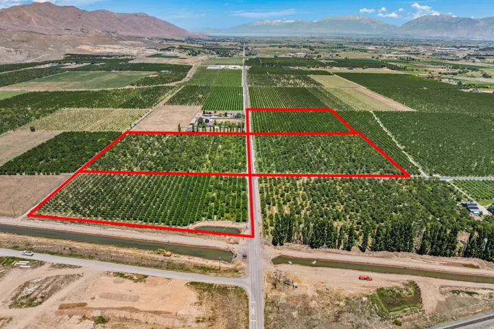 Expansive agricultural property featuring multiple cultivated fields and mature cherry trees