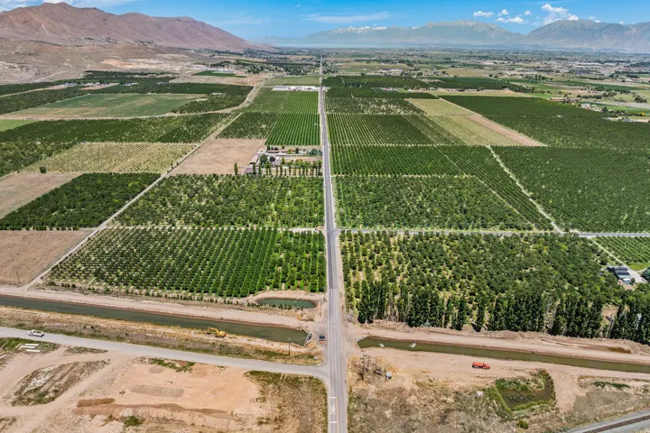 Expansive agricultural property featuring multiple cultivated fields and mature cherry trees