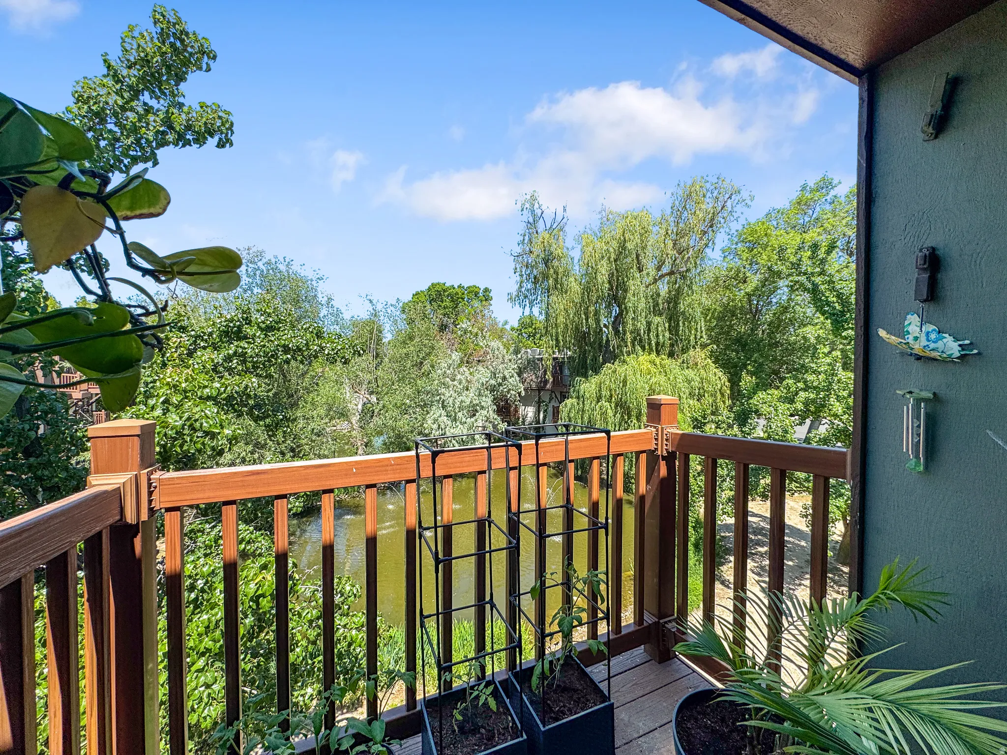 Private balcony featuring wood-finish railings and decking