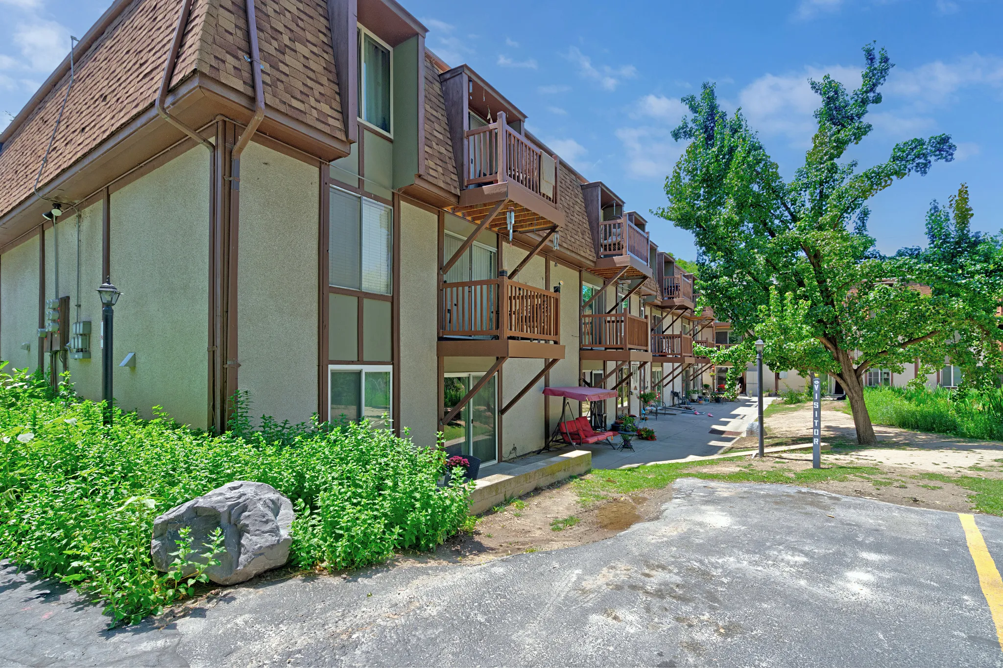 Multi-level building with stucco exterior and brown trim