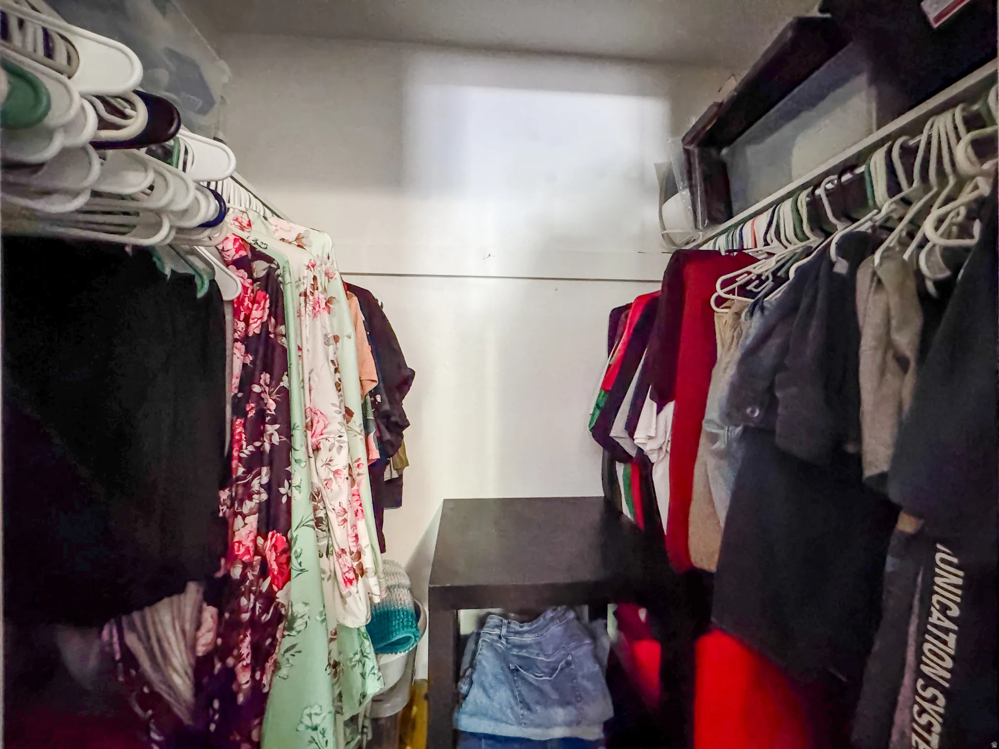 Built-in shelving and hanging rods offering versatile storage solutions within the closet space