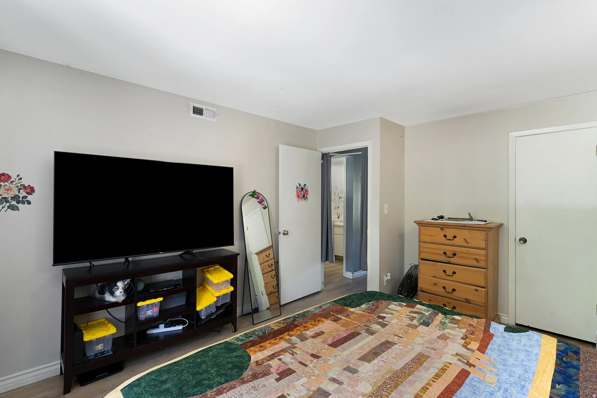 Interior room featuring neutral wall paint and wood-finish flooring