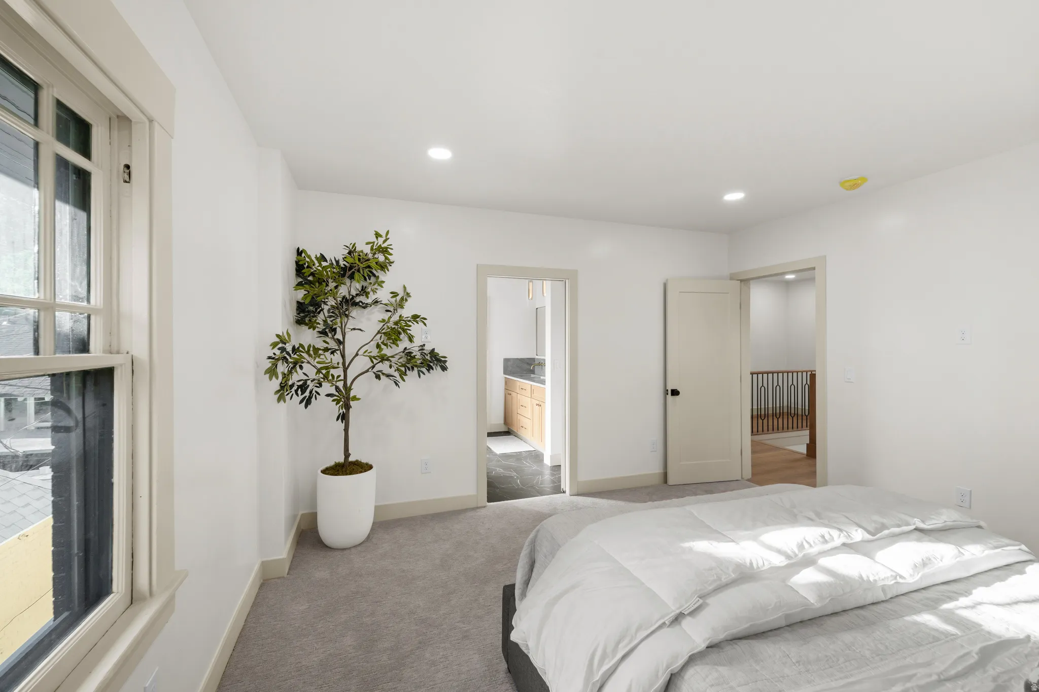 Carpeted room with recessed lighting and neutral wall paint