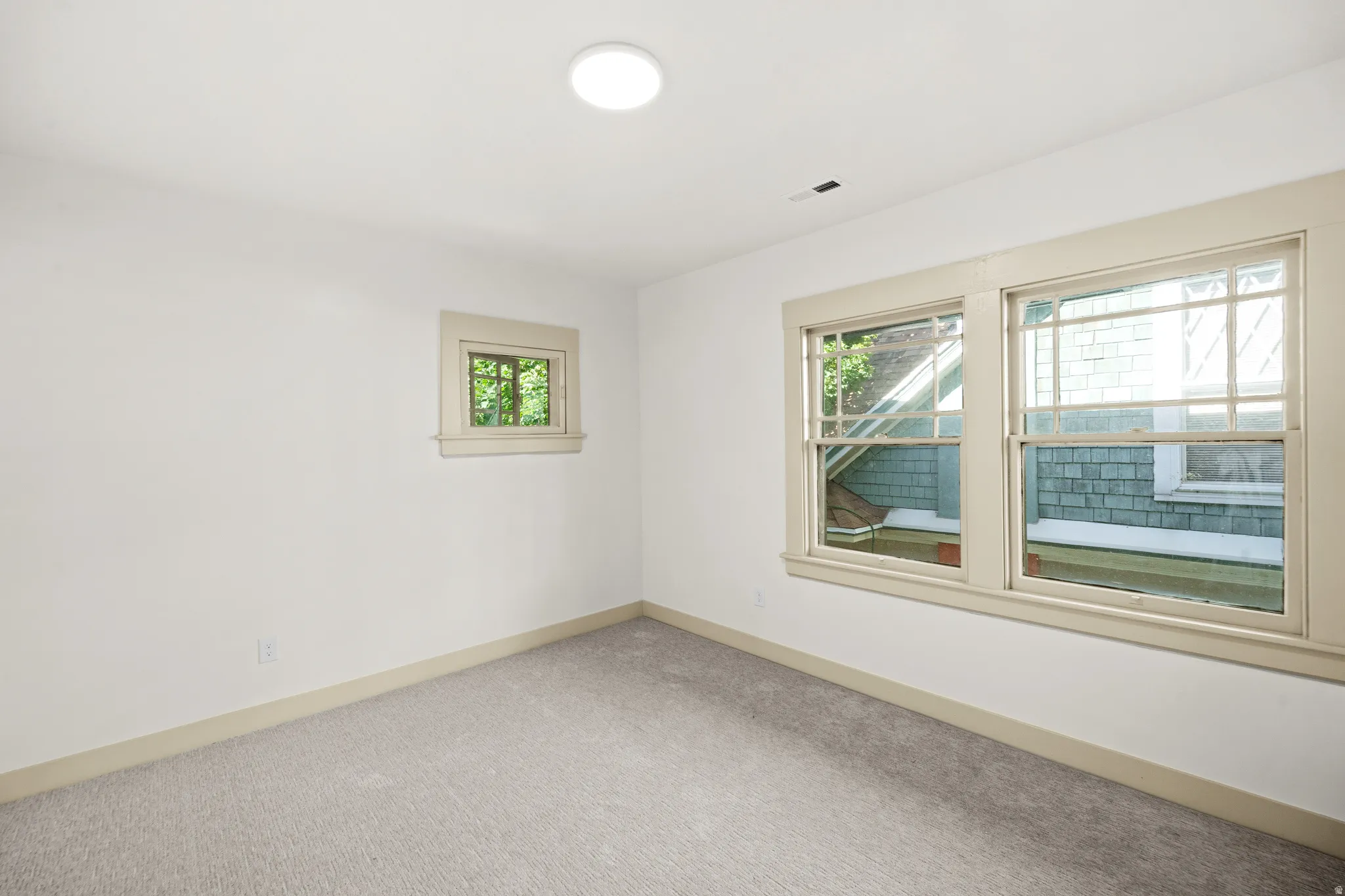 Freshly painted interior with light gray carpeting and white walls