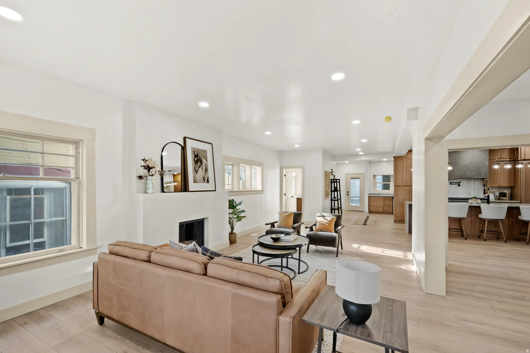 Open-concept living area featuring light wood-finish flooring and recessed lighting