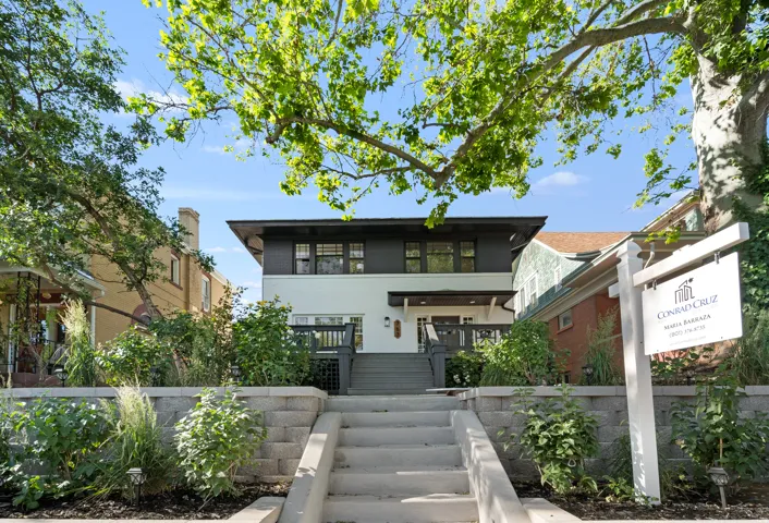 Two-story residence featuring a dark gray and white exterior with dark trim
