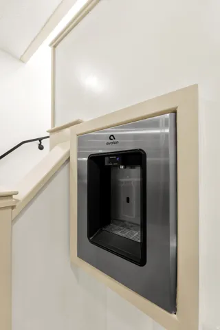 Built-in water dispenser with stainless steel finish and black trim