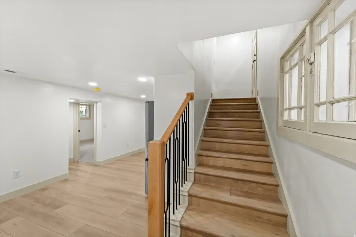 Hardwood staircase with wrought iron and wood handrail